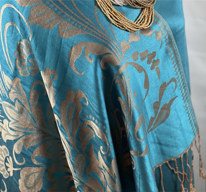 Aqua Pashmina, Gold Detail, Fringed Shawl, Elegant Wrap, Soft Drapery, Luxurious Feel, Chic Accessory, Turquoise Shawl, Metallic Accent, Fashion Scarf, Versatile Wear, Sophisticated, Lightweight Wrap